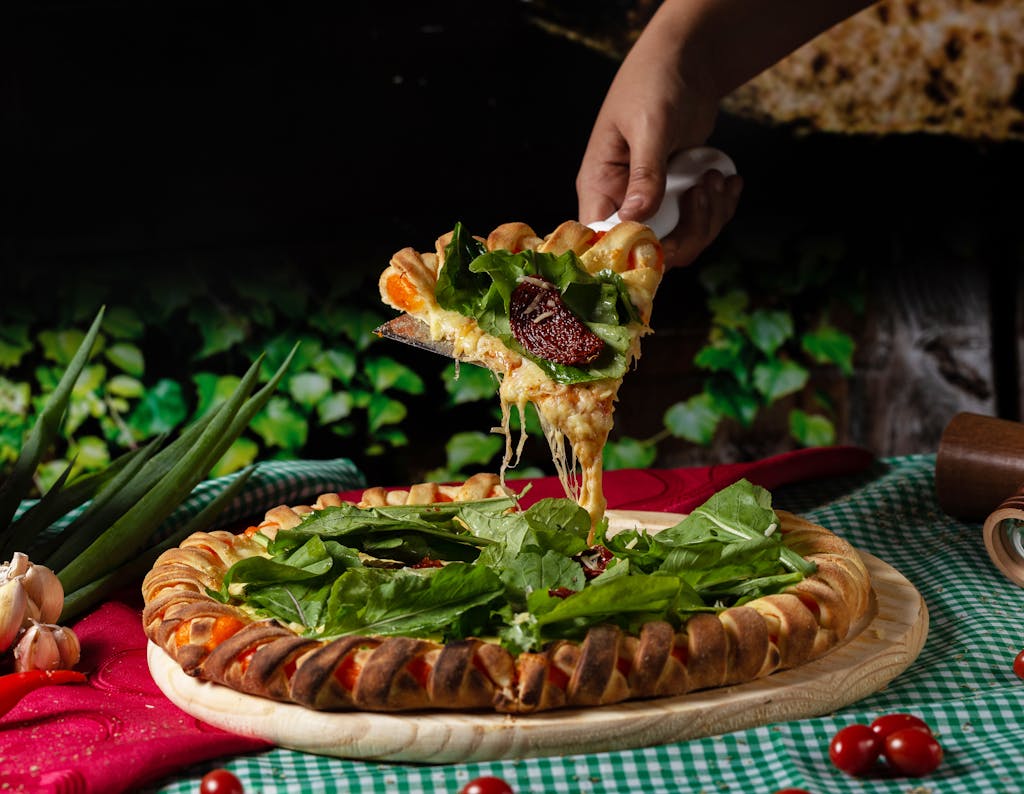 Person Holding a Vegetable Pizza