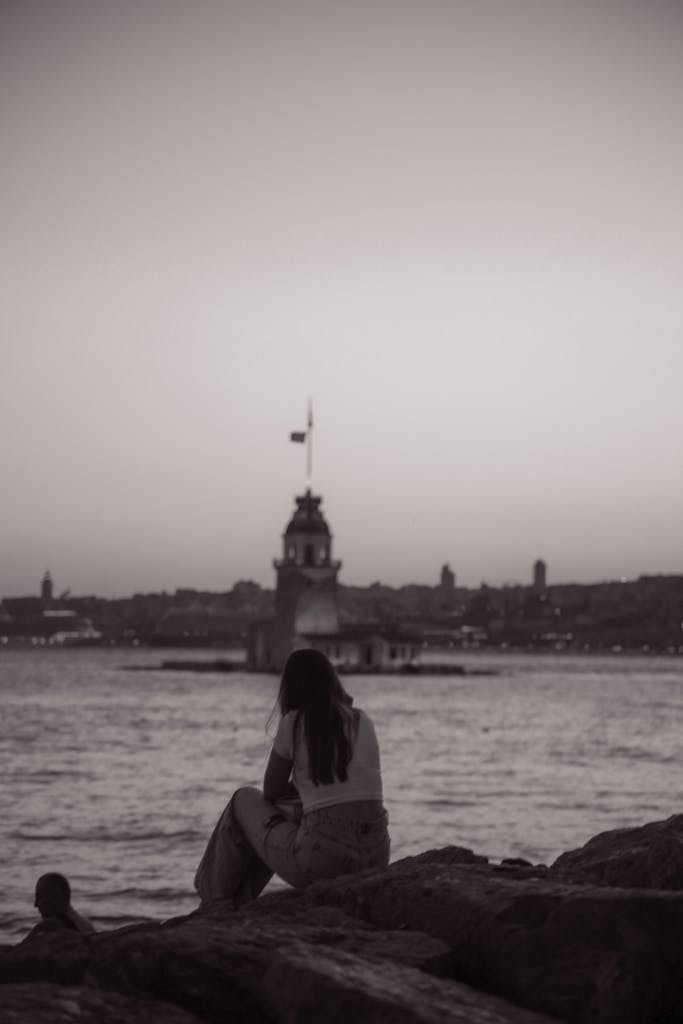 Woman Sitting on Rocks on Sea Shore in Istanbul